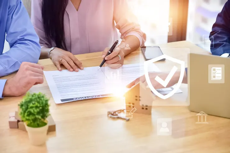 Two people signing a contract at a table, with digital icons representing secure transactions and documentation in the foreground Two people signing a contract at a table, with digital icons representing secure transactions and documentation in the foreground